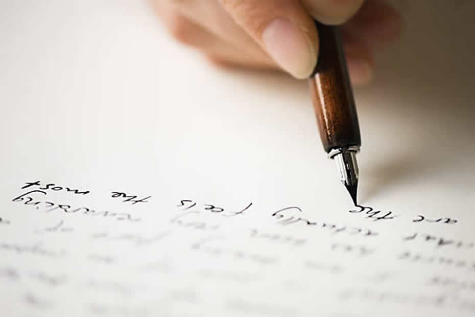 A picture of someone with a fountain pen writing a letter.